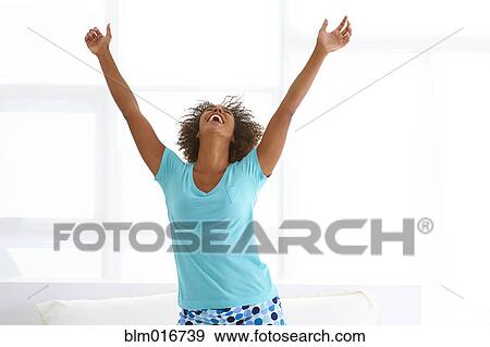 Stock Photo - Black woman cheering. Fotosearch