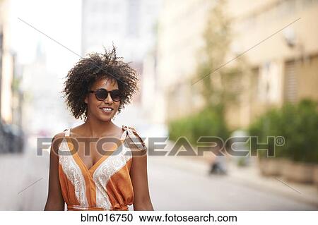 Stock Image - Black woman on city street. Fotosearch