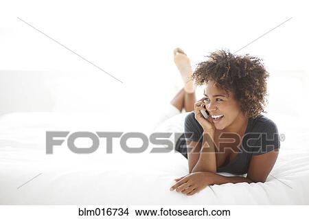 Picture - Black woman talking on cell phone. Fotosearch
