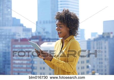 Stock Image - Black woman using tablet computer. Fotosearch
