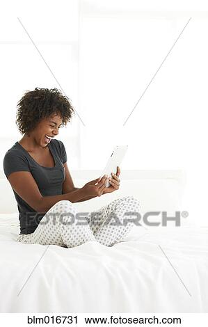 Black woman using tablet computer View Large Photo Image Stock Image - Black woman using tablet computer. Fotosearch