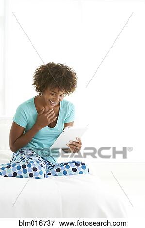 Stock Photo - Black woman using tablet computer. Fotosearch