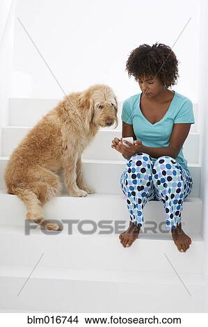 Black woman with dog using cell phone View Large Photo Image Picture - Black woman with dog using cell phone. Fotosearch