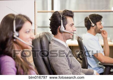 Stock Photo - Business people talking on headsets. Fotosearch