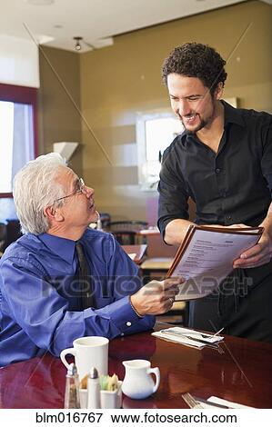 Businessman ordering food in cafe View Large Photo Image Stock Photo - Businessman ordering food in cafe. Fotosearch