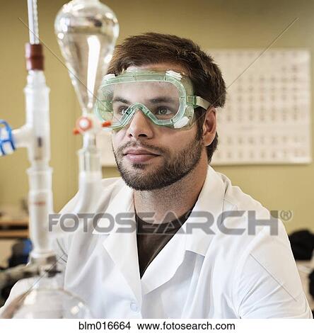 Picture - Caucasian student working in chemistry lab. Fotosearch