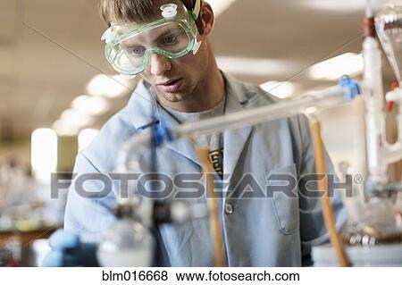 Stock Photo - Caucasian student working in chemistry lab. Fotosearch