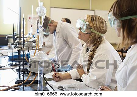Stock Photograph - Caucasian students working in chemistry lab. Fotosearch