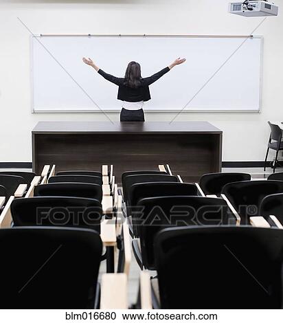 Caucasian teacher at whiteboard in empty classroom View Large Photo Image Stock Image - Caucasian teacher at whiteboard in empty classroom. Fotosearch