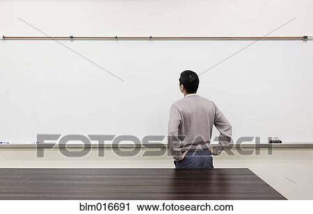 Chinese student examining empty whiteboard View Large Photo Image Stock Image - Chinese student examining empty whiteboard. Fotosearch