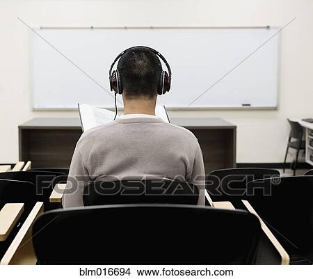 Chinese student listening to headphones in classroom View Large Photo Image Picture - Chinese student listening to headphones in classroom. Fotosearch