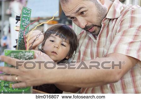 Stock Photo - Father and son playing with microchips. Fotosearch
