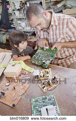 Stock Photo - Father and son playing with microchips. Fotosearch