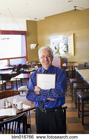 Hispanic cafe owner holding clipboard View Large Photo Image Stock Photograph - Hispanic cafe owner holding clipboard. Fotosearch