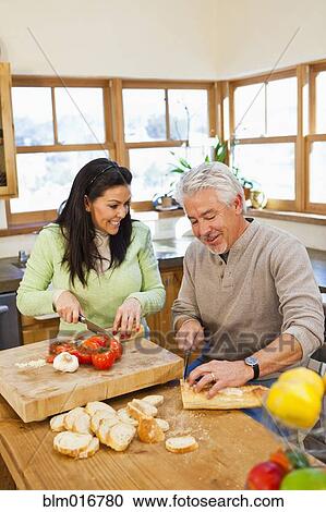 Hispanic couple cooking together in kitchen View Large Photo Image Stock Image - Hispanic couple cooking together in kitchen. Fotosearch