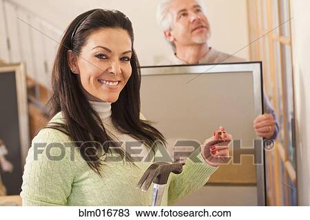 Hispanic couple decorating home together View Large Photo Image Stock Image - Hispanic couple decorating home together. Fotosearch