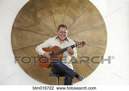 Hispanic man playing guitar View Large Photo Image Stock Image - Hispanic man playing guitar . Fotosearch