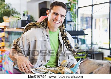 Mixed race pet store owner with animals View Large Photo Image Picture - Mixed race pet store owner with animals. Fotosearch