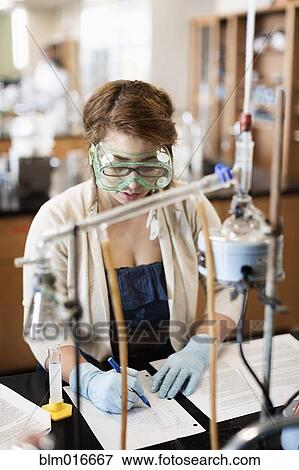 Stock Photo - Mixed race student working in chemistry lab. Fotosearch