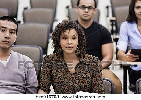 Stock Image - Students sitting in classroom. Fotosearch