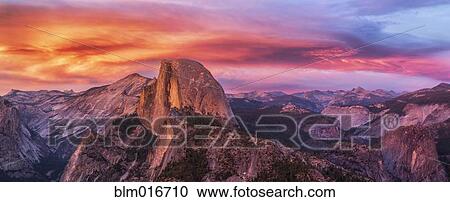 Stock Image - Sun setting over rocky landscape. Fotosearch