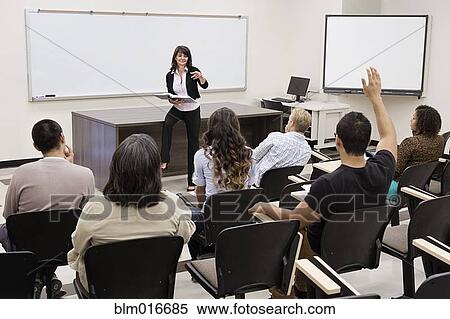Stock Photography - Teacher calling on students in classroom. Fotosearch