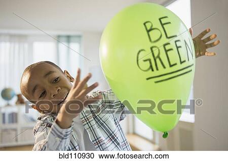 African American boy playing with? 'be green' balloo View Large Photo Image Stock Image - African American boy playing with? 'be green' balloo. Fotosearch