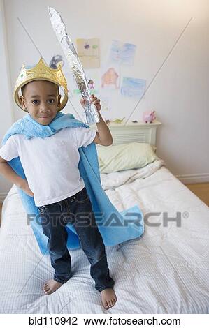 African American boy wearing costume on bed View Large Photo Image Stock Image - African American boy wearing costume on bed. Fotosearch