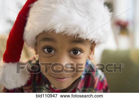 Stock Photo - African American boy wearing Santa hat. Fotosearch