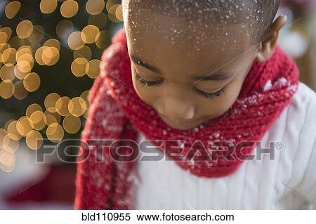 Stock Photography - African American boy wearing scarf in snow. Fotosearch