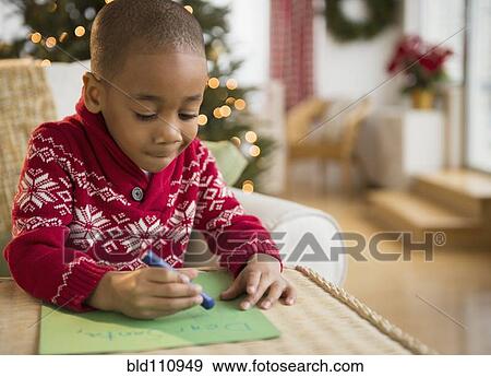 Stock Photo - African American boy writing letter to Santa. Fotosearch