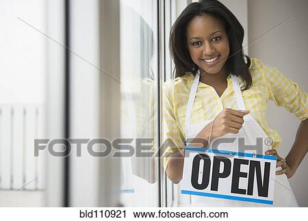Stock Image - African American business owner with? 'open' sig. Fotosearch