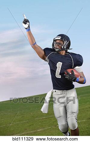 Stock Photo - African American football player cheering in game. Fotosearch