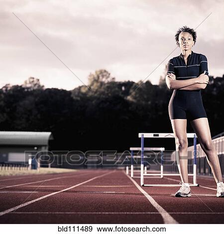 Stock Photo - African American runner standing on track. Fotosearch