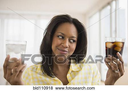 African American woman choosing water or soda View Large Photo Image Stock Photo - African American woman choosing water or soda. Fotosearch