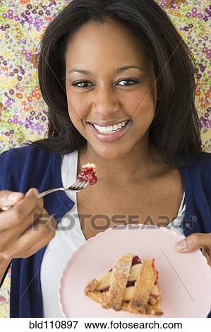 African American woman eating dessert View Large Photo Image Stock Photo - African American woman eating dessert. Fotosearch
