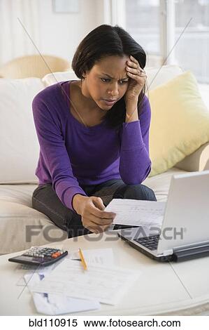 African American woman paying bills with laptop View Large Photo Image Stock Photography - African American woman paying bills with laptop. Fotosearch