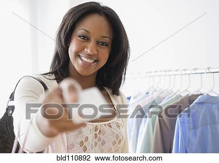 Stock Image - African American woman paying with credit card. Fotosearch