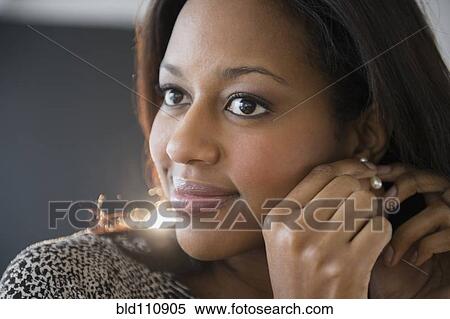 African American woman putting on earrings View Large Photo Image Stock Photography - African American woman putting on earrings. Fotosearch