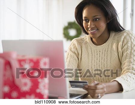African American woman shopping online View Large Photo Image Stock Photo - African American woman shopping online. Fotosearch