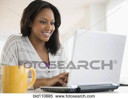 African American woman using laptop View Large Photo Image Stock Photography - African American woman using laptop. Fotosearch