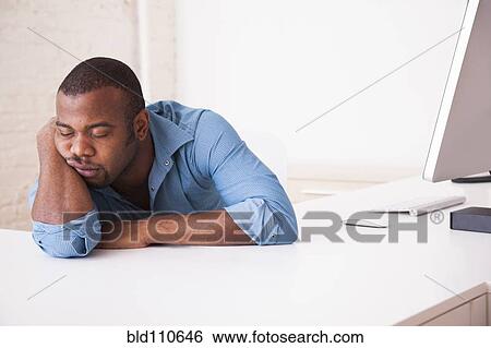 Black Businessman Sleeping At Desk Stock Photograph Bld110646