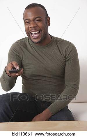 Black man using remote control View Large Photo Image Stock Image - Black man using remote control. Fotosearch
