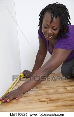 Black woman measuring wall View Large Photo Image Stock Photography - Black woman measuring wall. Fotosearch