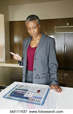 Stock Photo - Businesswoman using computer in table. Fotosearch