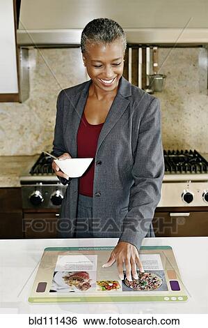 Stock Photograph - Businesswoman using computer in table. Fotosearch