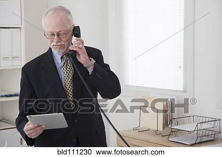Caucasian businessman working in office View Large Photo Image Stock Image - Caucasian businessman working in office. Fotosearch