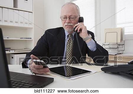 Stock Photo - Caucasian businessman working in office. Fotosearch