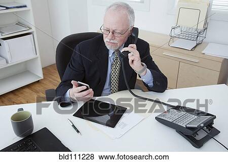 Stock Photo - Caucasian businessman working in office. Fotosearch