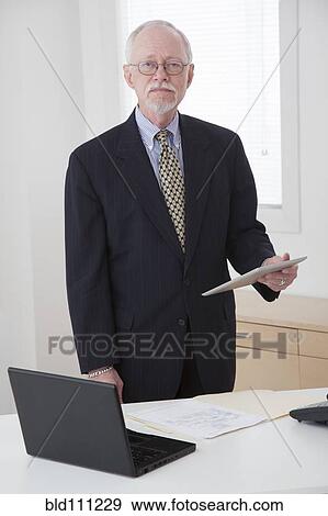 Stock Photo - Caucasian businessman working in office. Fotosearch